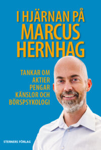Bokomslag med titeln ”I hjärnan på Marcus Hernhag” i gul text mot blå bakgrund. På omslaget finns även ett frilagt foto av författaren, en leende man med kal hjässa och skägg.